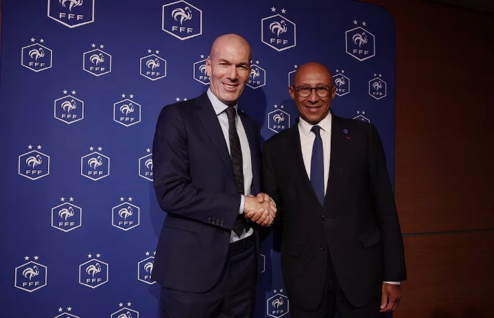 Zinedine Zidane shaking hands with a French executive