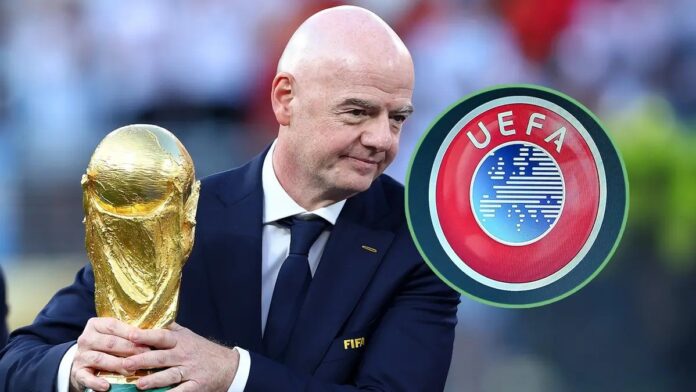 FIFA President holding the World Cup trophy