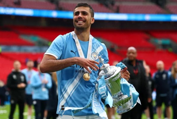 Rodri celebrating the FA Cup trophy for Manchester City after their triumph against Chelsea in May 2026
